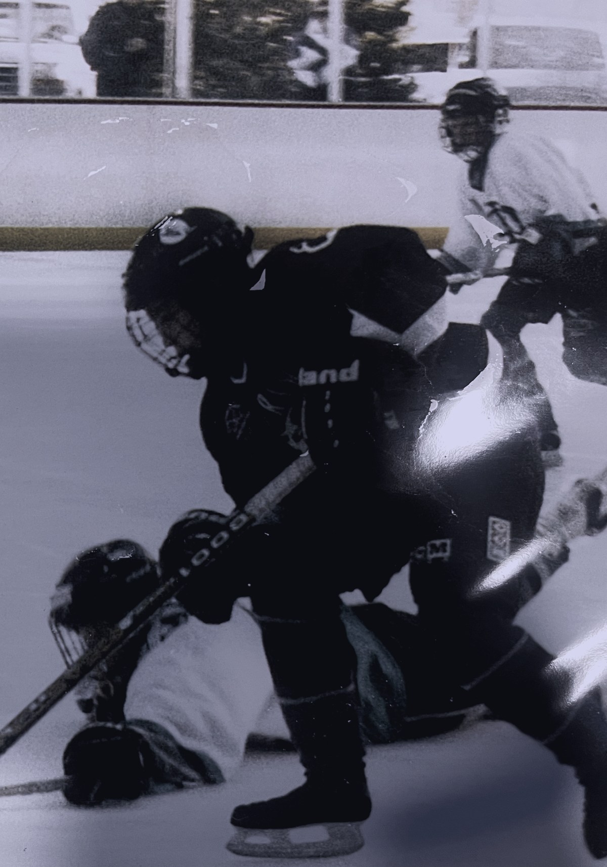 RK as a boy, driving the puck along the boards in a youth hockey game.